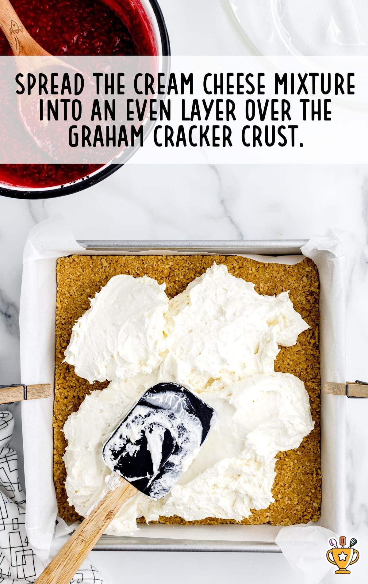 cream cheese mixture spread into the even layer over the graham cracker crust in a baking dish