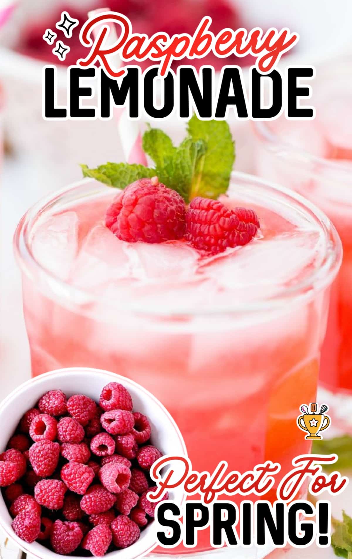 a glass of Raspberry Lemonade topped with raspberries and mint