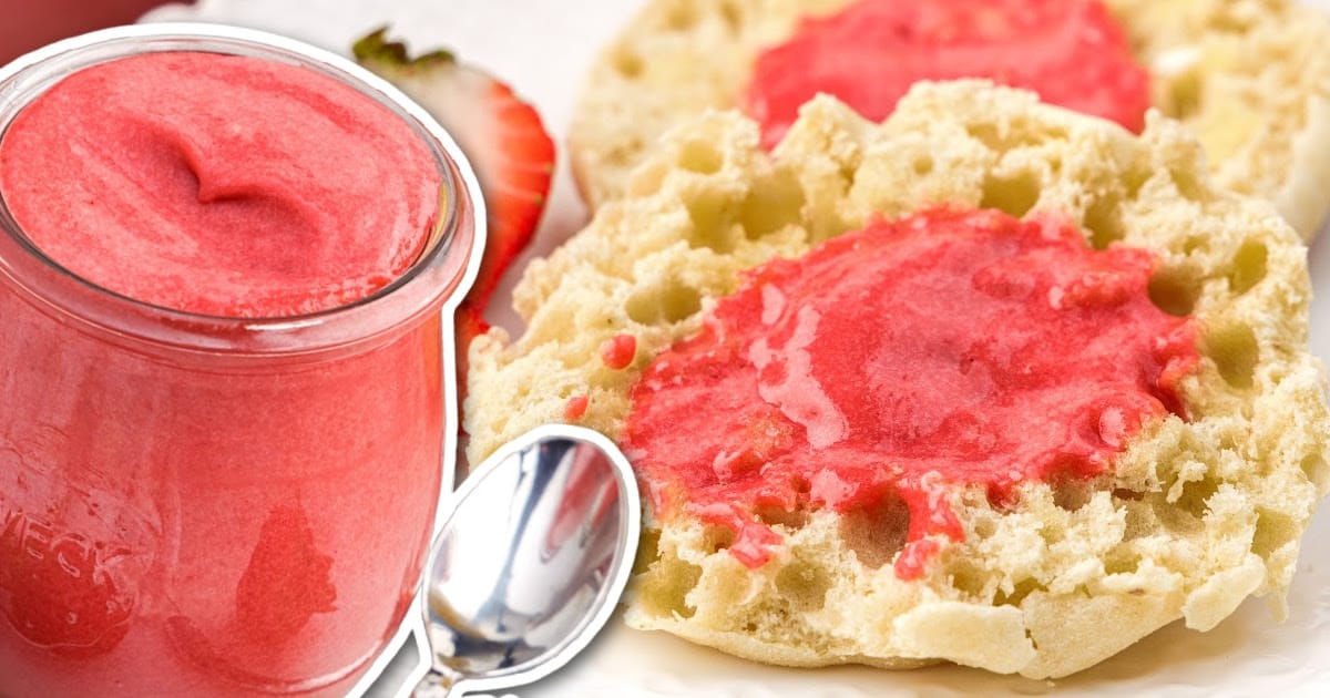Strawberry Curd in a glass cup with a spoon grabbing a piece