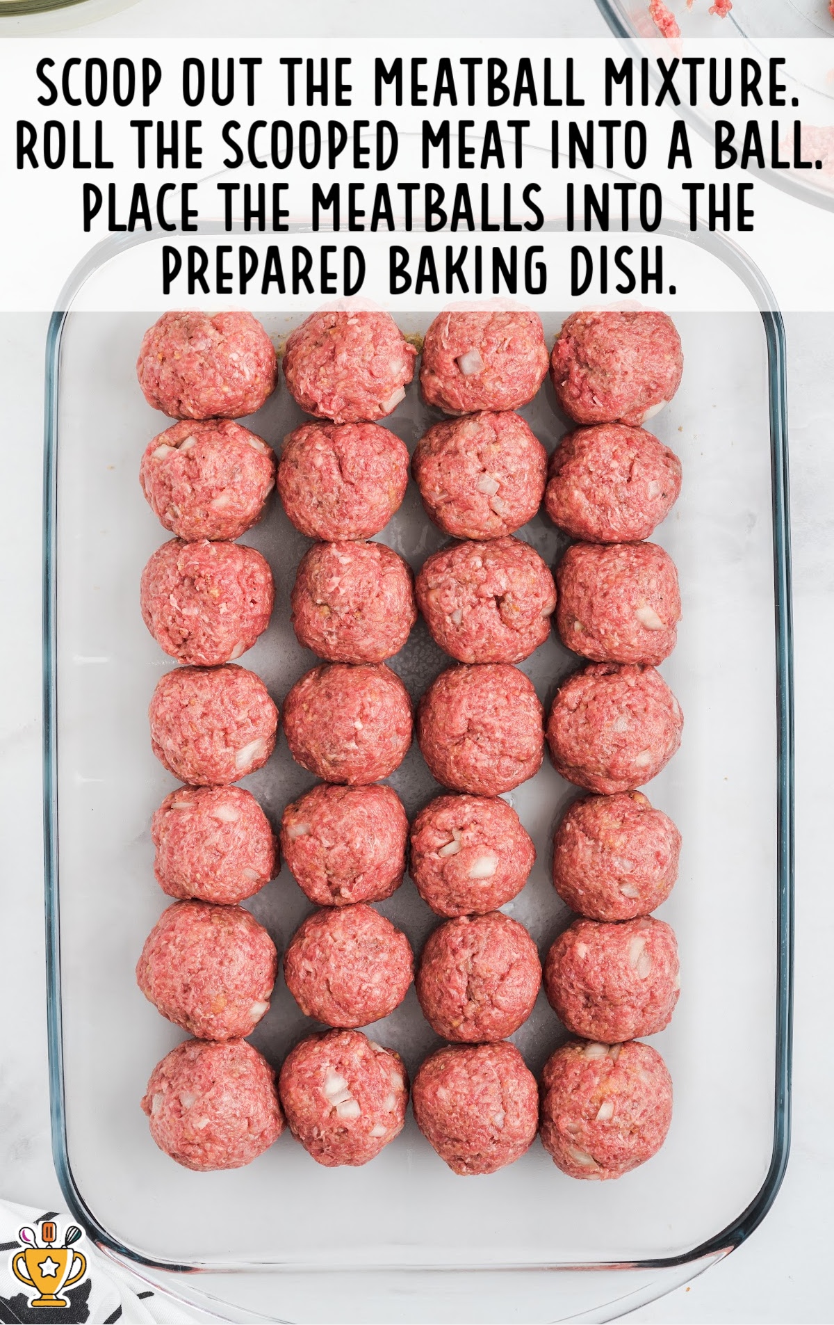 meatball mixture scooped out and made into balls and then put in a baking dish