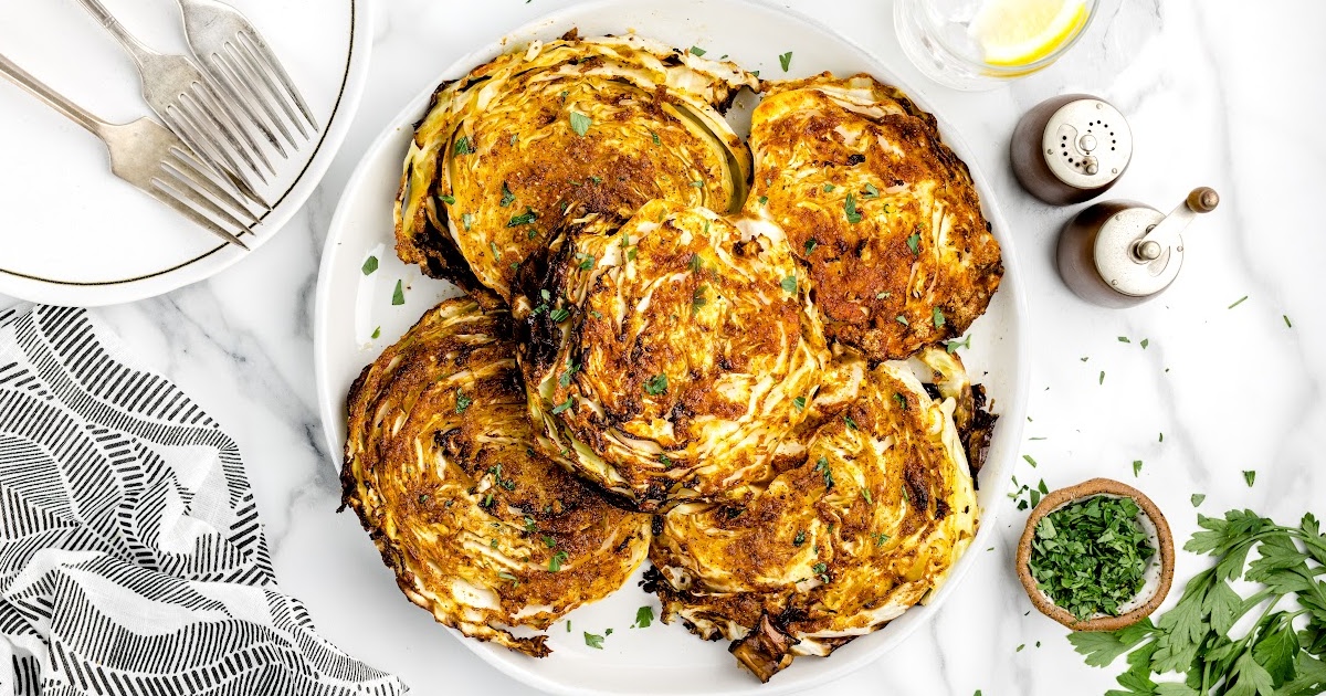 a plate of fried Cabbage garnished with parsley