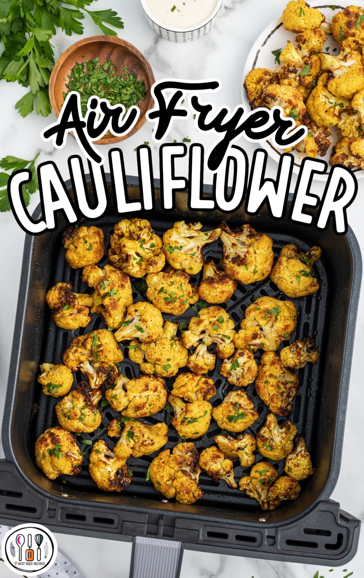 overhead shot of cauliflower garnished with parsley in a air fryer