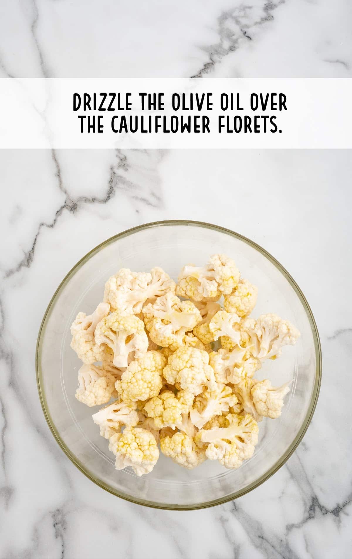 oil drizzled over the cauliflower in a bowl