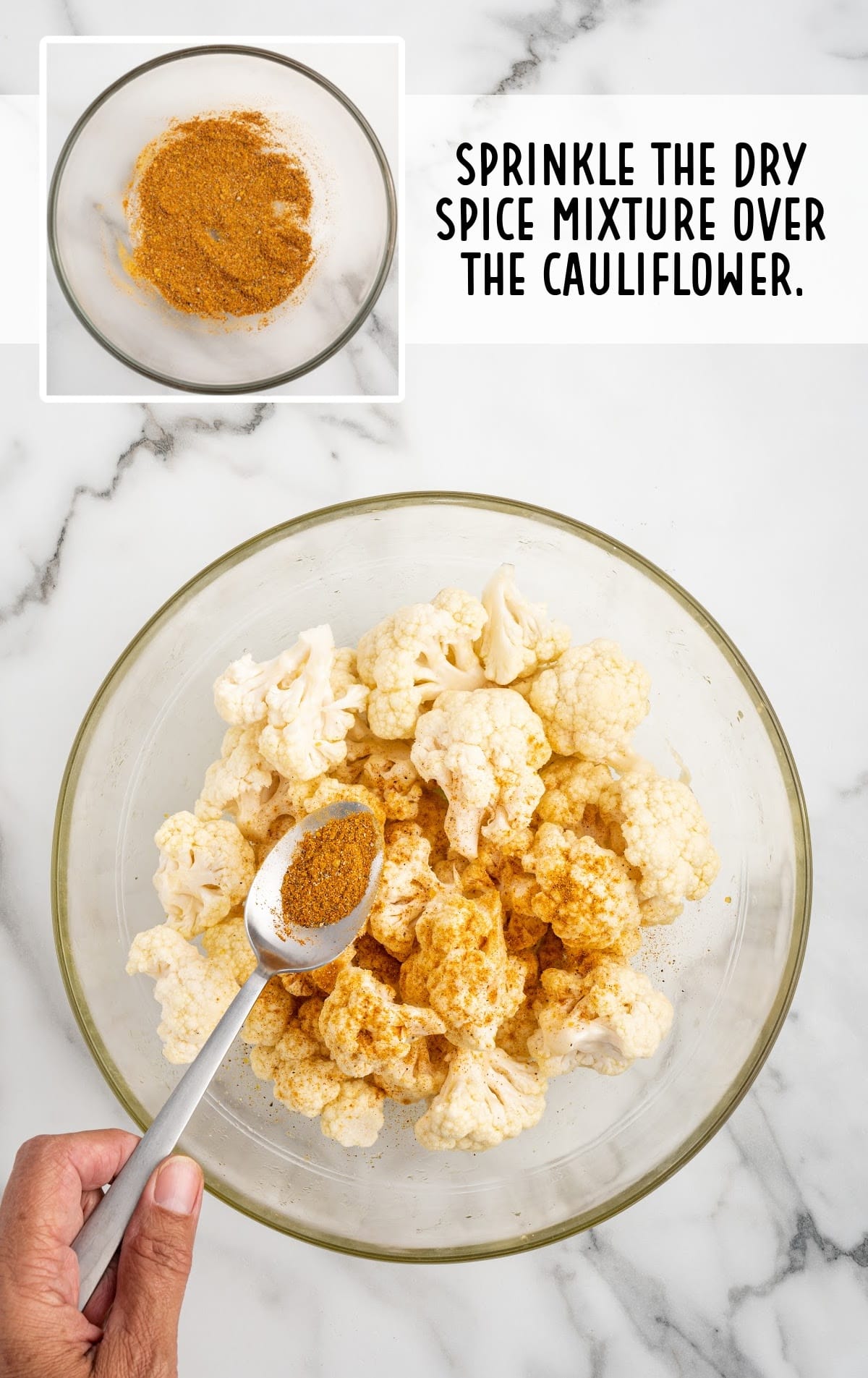 dry spice mix sprinkled over the cauliflower in a bowl