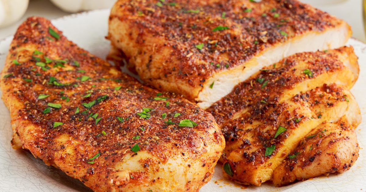 overhead shot of a couple of pieces of Air Fryer Chicken Breasts in a air fryer