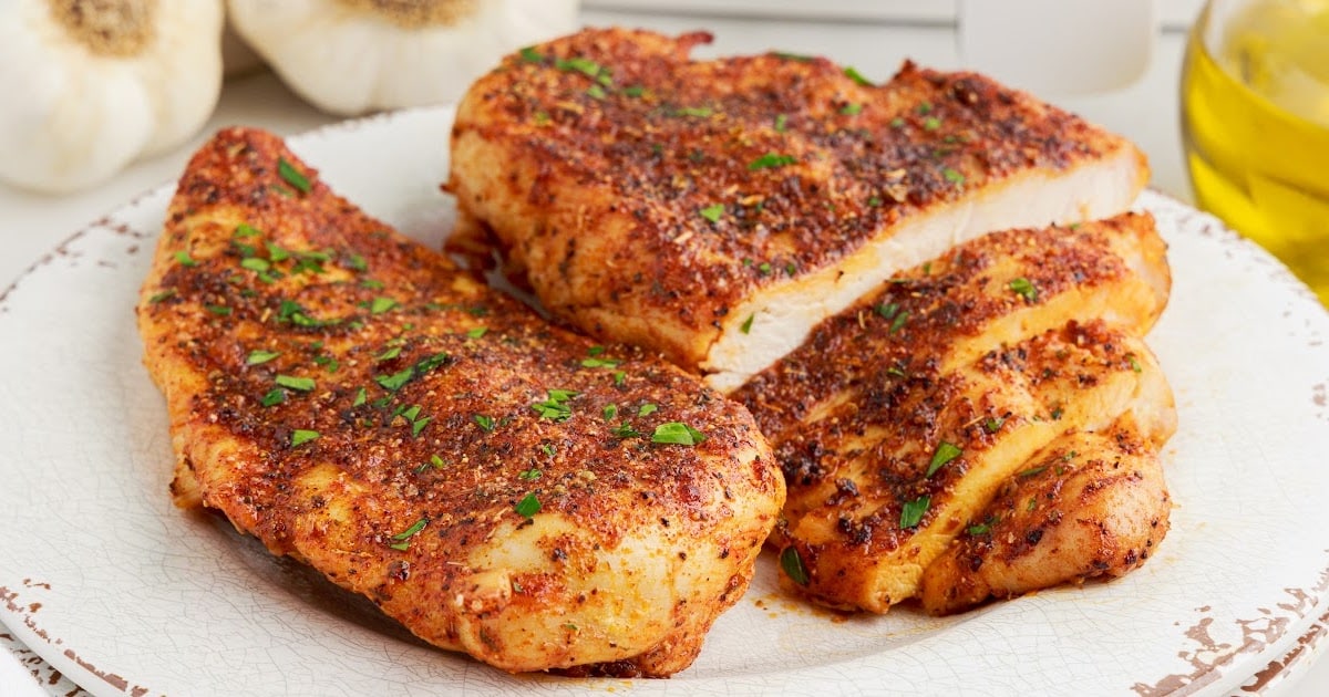 overhead shot of a couple of pieces of Air Fryer Chicken Breasts in a air fryer