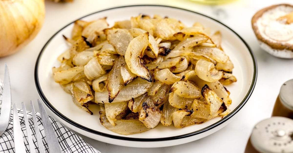 a close up shot of Air Fryer Onions on a plate