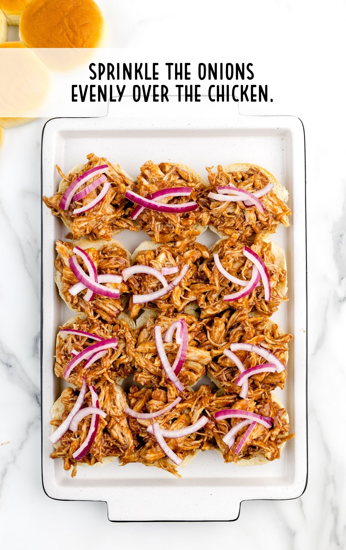 onions sprinkled evenly over the chicken in the baking dish
