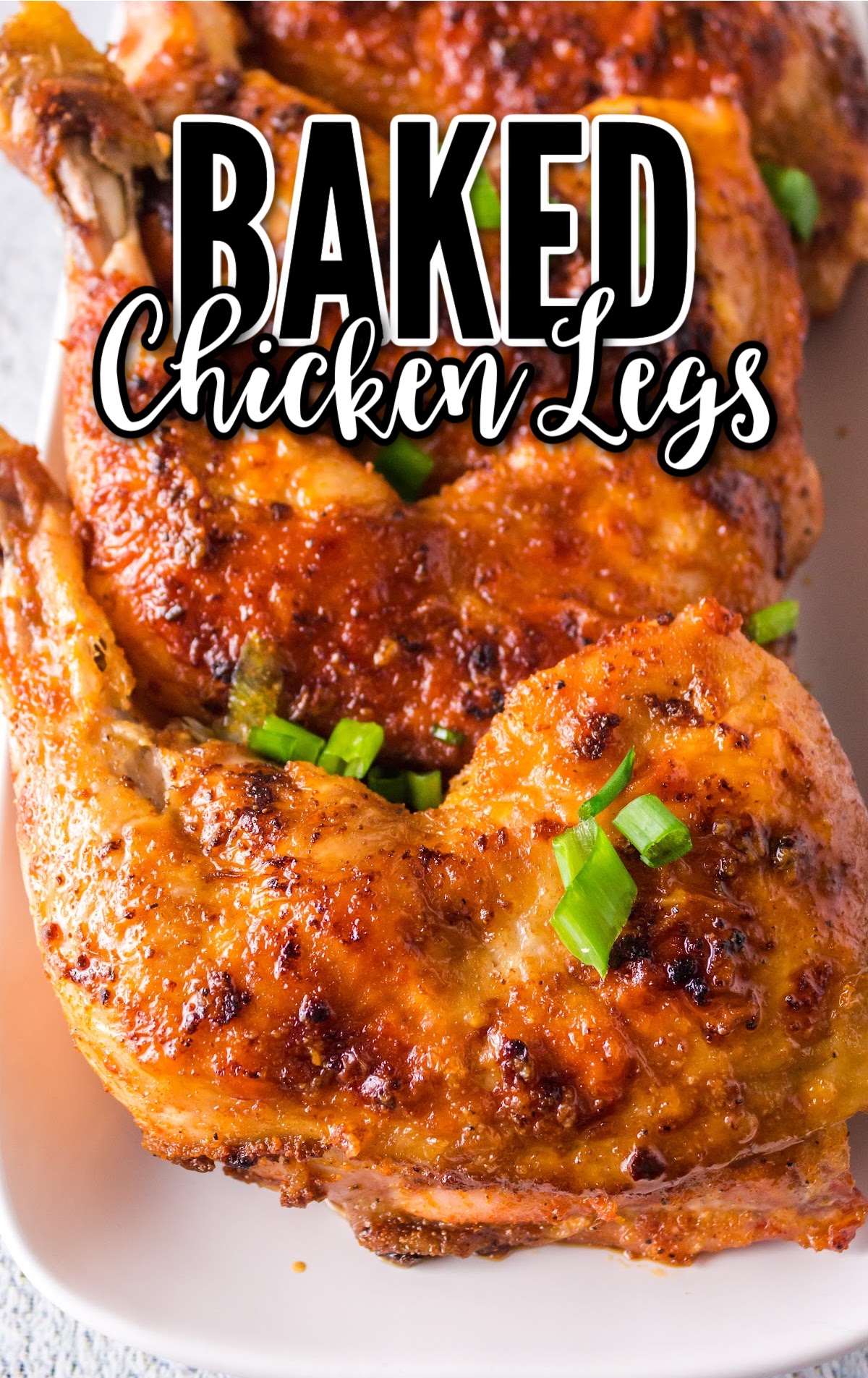 close up shot of Baked Chicken Legs garnished with green onions on a plate