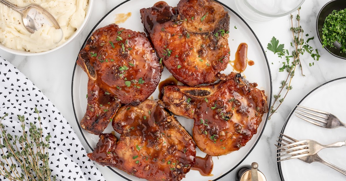 glazed pork chops served on a plate with mashed potatoes