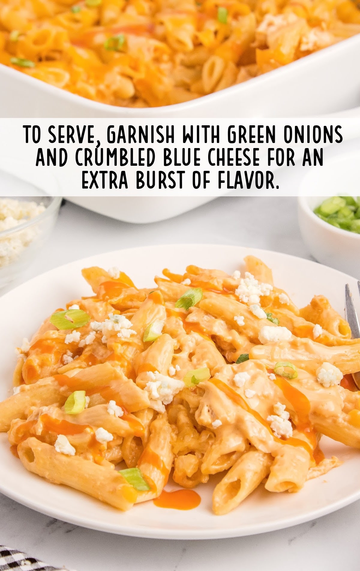 a plate of pasta garnished with green onions and blue cheese