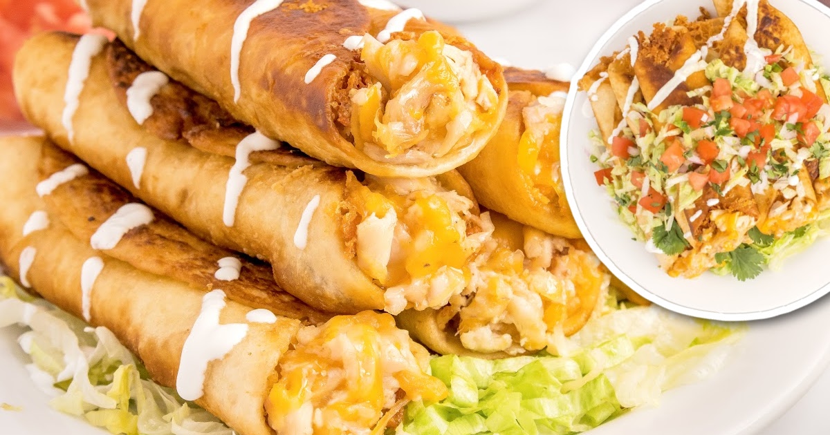 overhead shot of a plate of Chicken Flautas topped on a bead of avocado and garnished with toppings