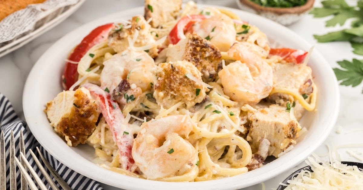 overhead shot of a bowl of Carbonara Pasta topped with bacon bits, cheese, and parsley