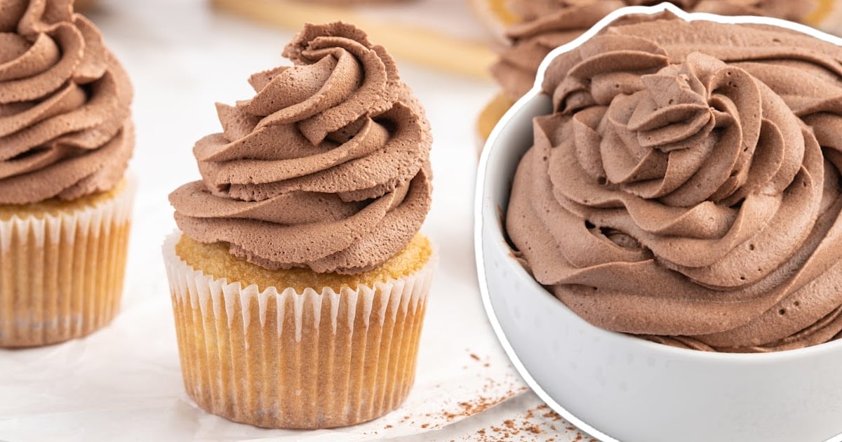 close up shot of vanilla cupcakes topped with Chocolate Whipped Cream