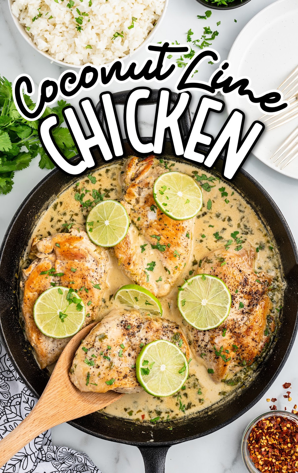 overhead shot of a skillet of chicken topped with slices of lime