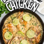 overhead shot of a skillet of chicken topped with slices of lime