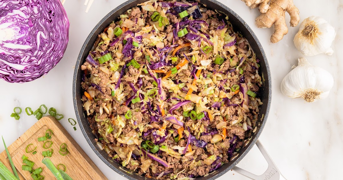 a close up shot of Crack Slaw in a skillet with a wooden spoon