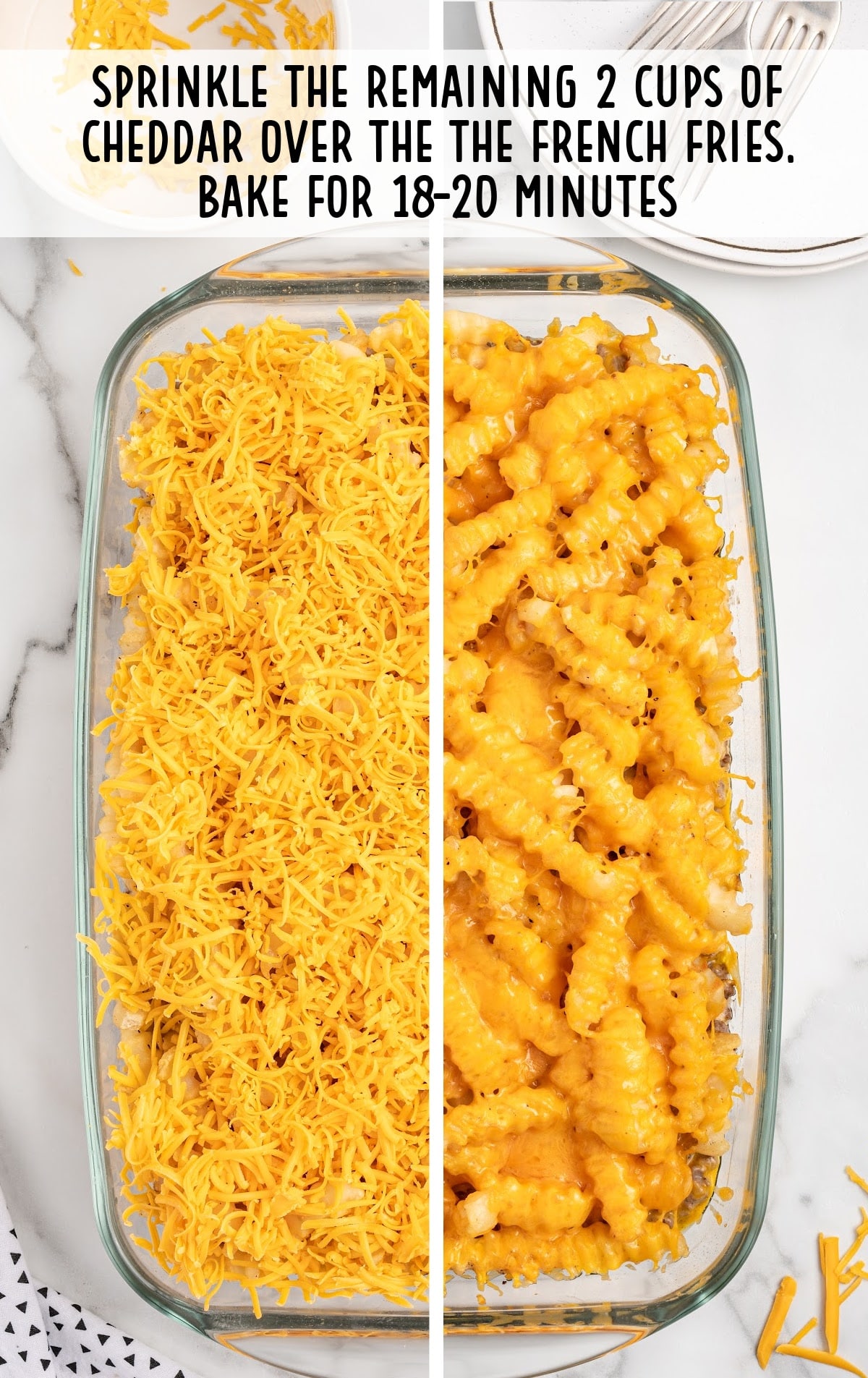 cheddar cheese sprinkled on top of the French fries in a baking dish