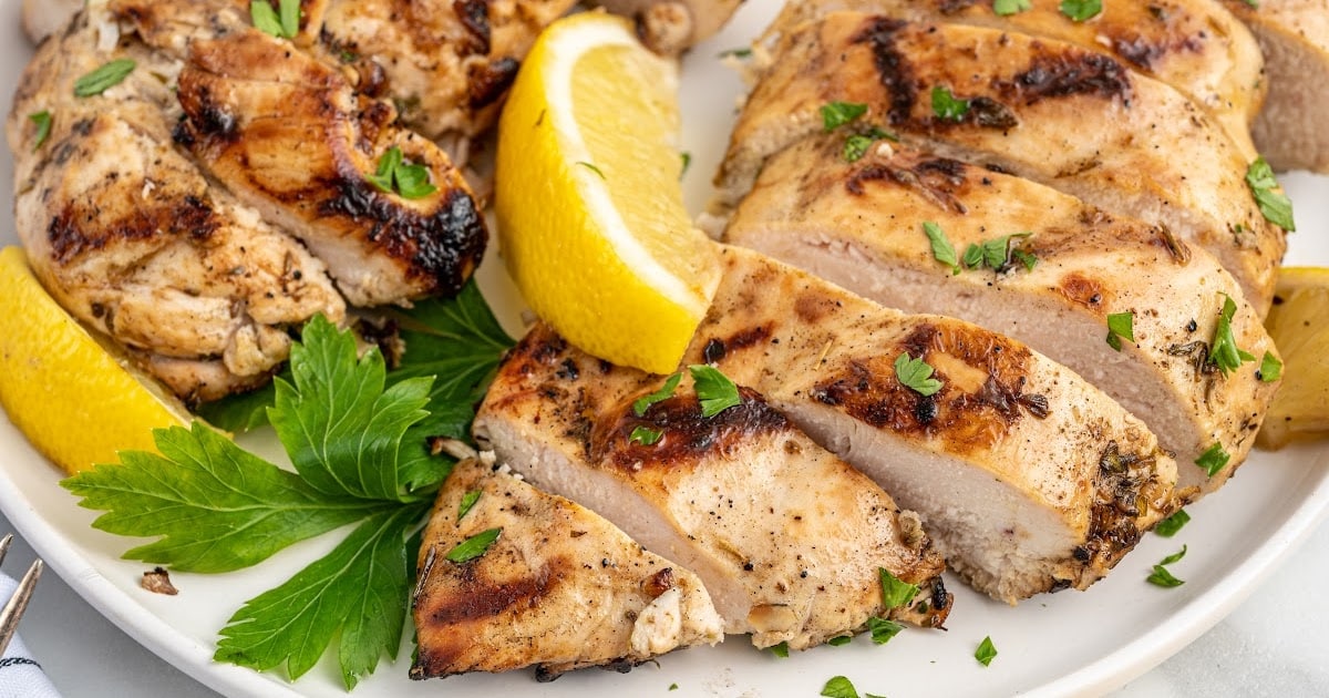 overhead shot of Greek Chicken Marinade on a plate sliced into pieces