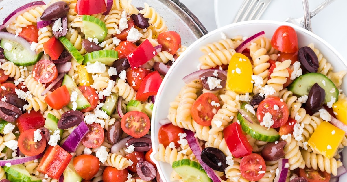 two bowls of greek salad topped with feta cheese