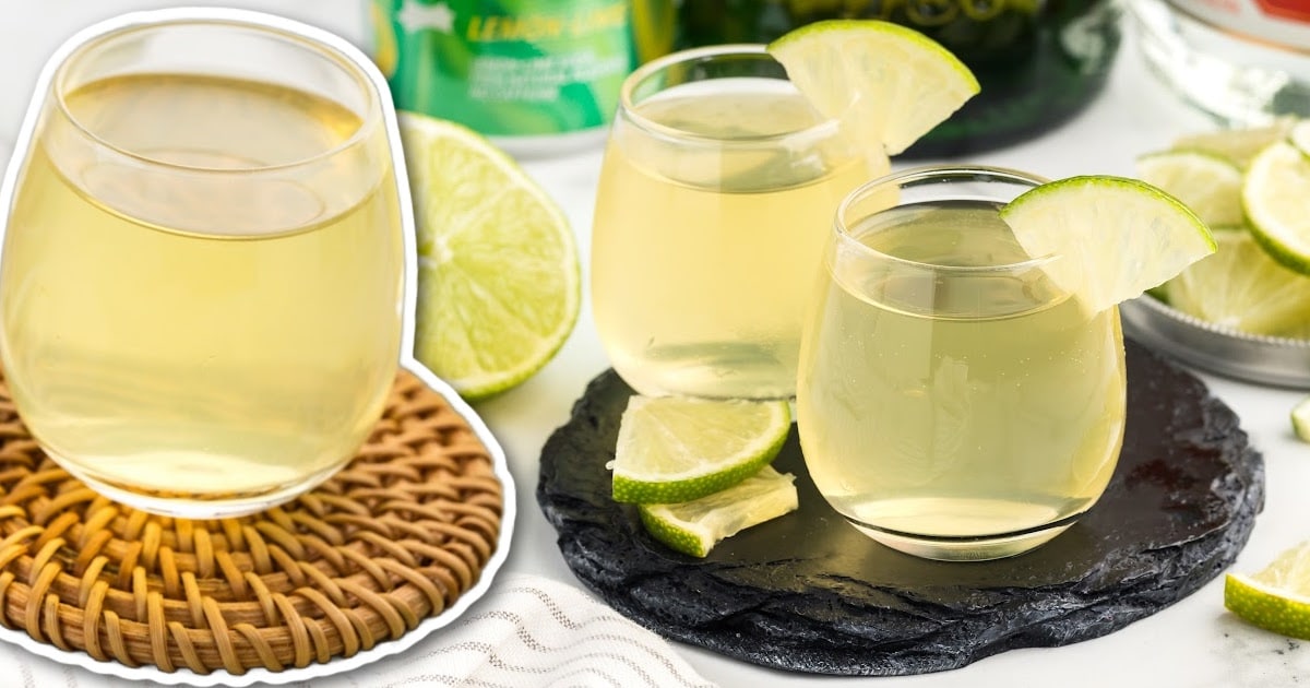 a close up shot of Green Tea Shots in a glass cup garnished with a slice of lime on a tray