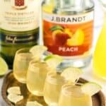 a close up shot of Green Tea Shots in a glass cup garnished with a slice of lime on a tray