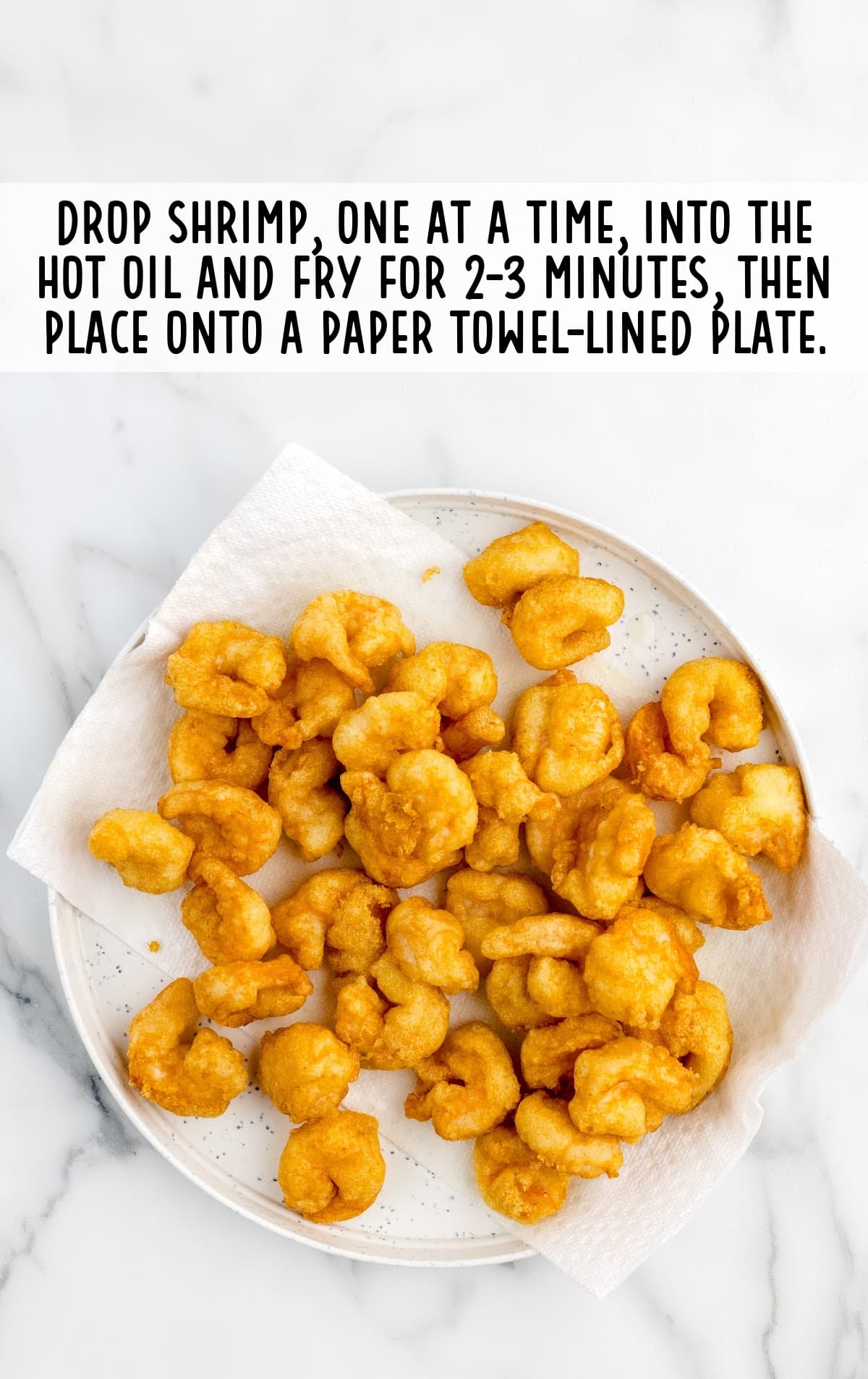 fried shrimp placed on a towel lined plate