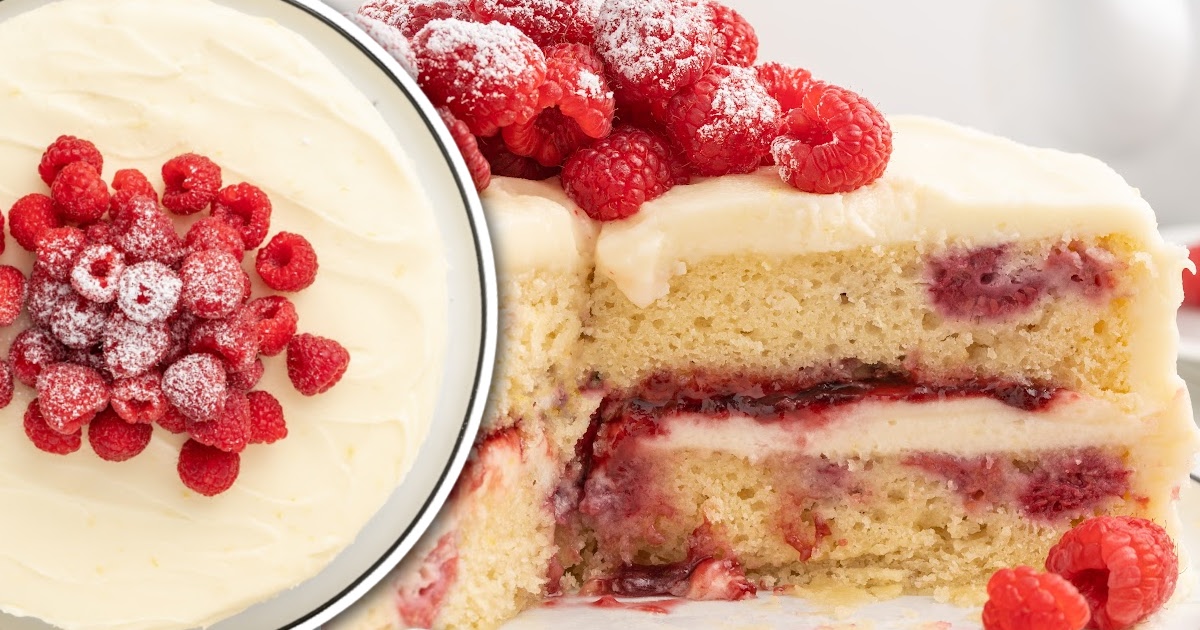 a cake topped with raspberries and powdered sugar with a slice missing on a cake stand