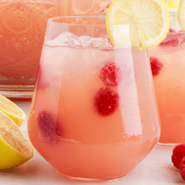 close up shot of Party Punch with lemon slices and raspberries