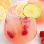 close up shot of glasses of Party Punch with lemon slices and raspberrie