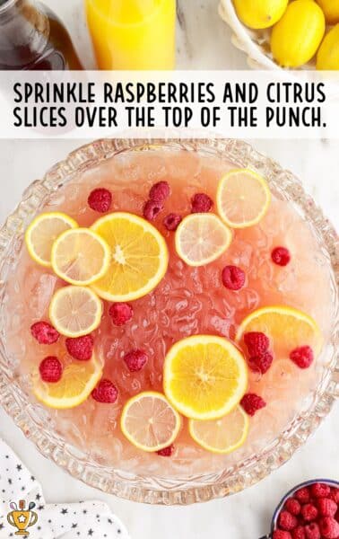 raspberries and slices of lemon added to the punch bowl