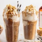 a close up shot of a couple of Peanut Butter Root Beer in a tall glass