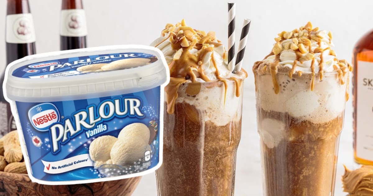 overhead shot of a couple of Peanut Butter Root Beer in a tall glass topped with whipped cream