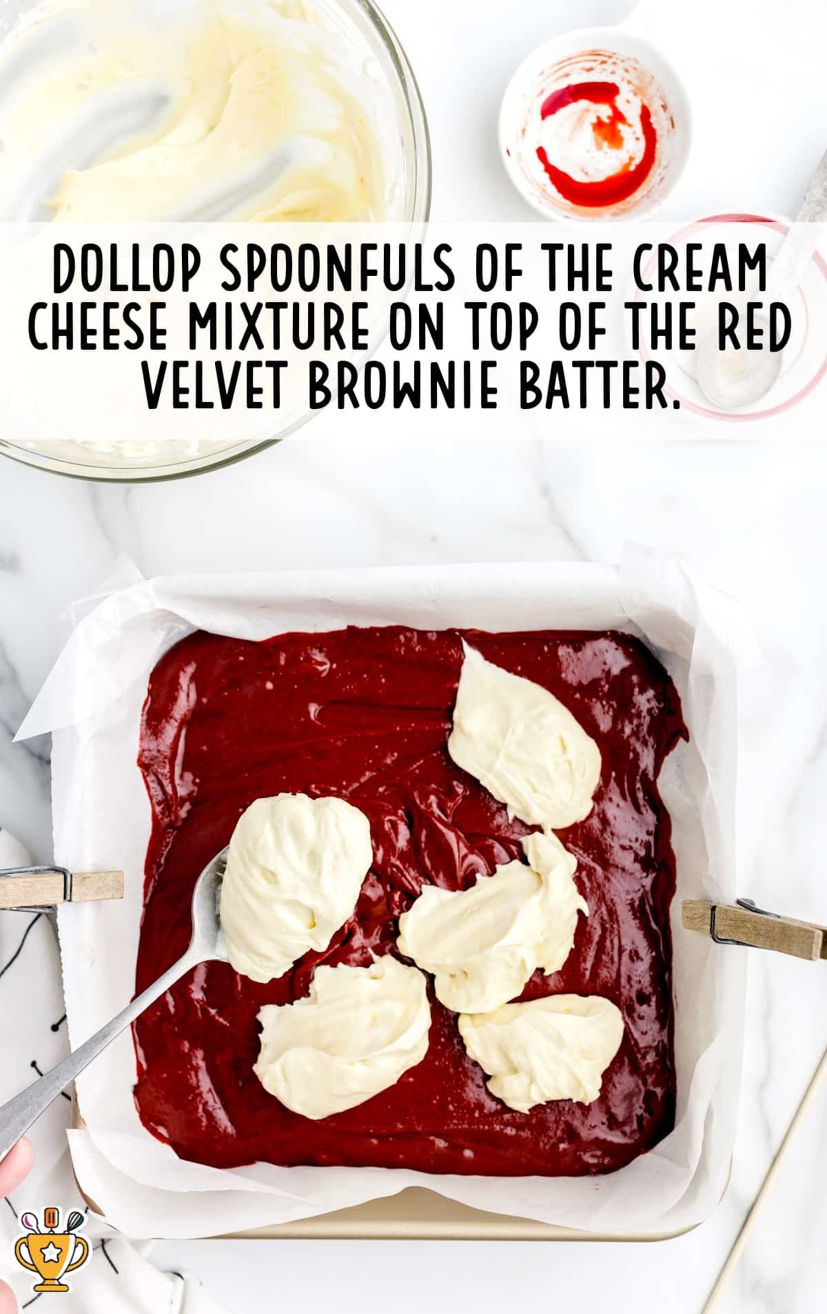 cream cheese dollop on top of the red velvet brownie batter