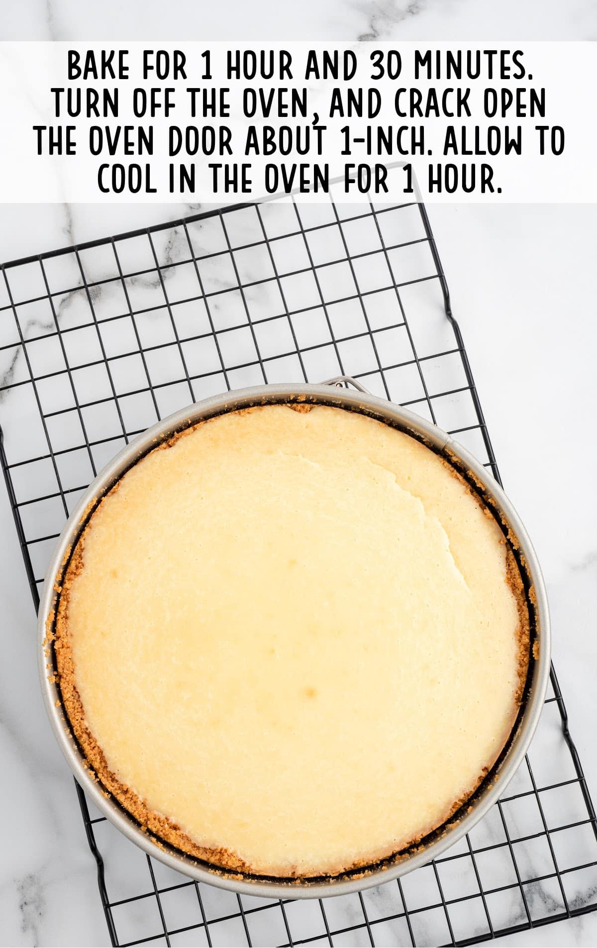 baked cheesecake on a cooling rack still sitting in pan