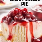 slice of cherry cream cheese pie on a plate with cherry pie filling spilling over the side