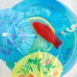 overhead shot of a fishbowl drink with a swedish fish for garnish