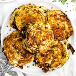 a plate of fried Cabbage garnished with parsley