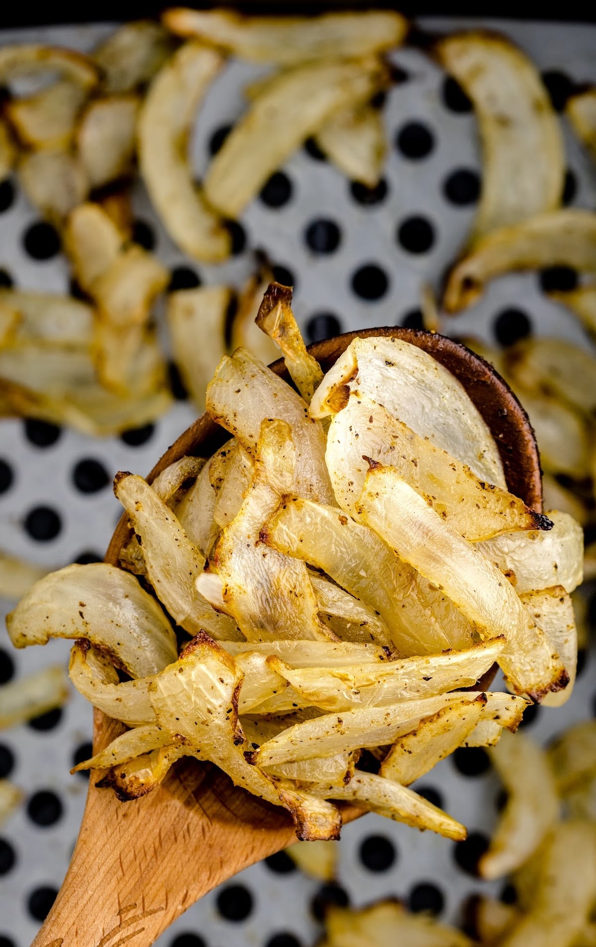 overhead shot of spoon full of Air Fryer Onions