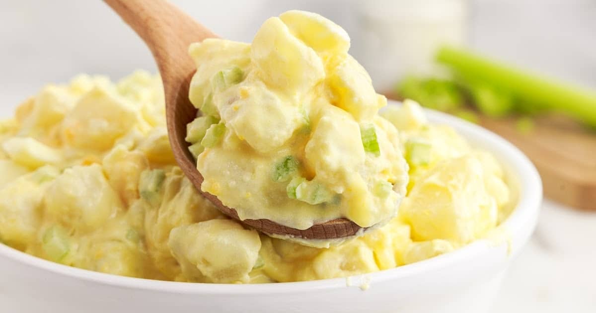 scoop of potato salad on a wooden spoon