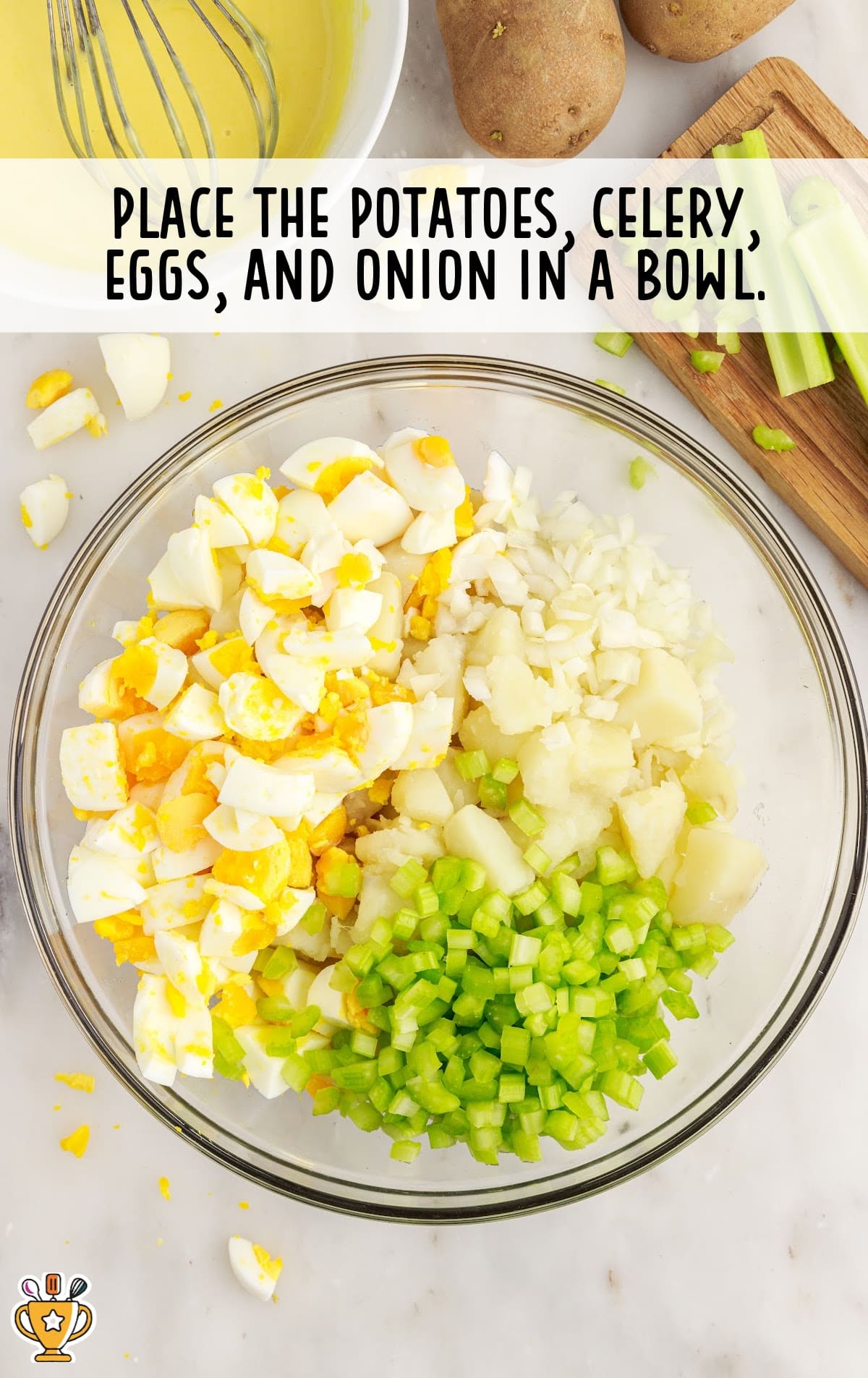 potatoes, celery, eggs, and onion placed in a bowl