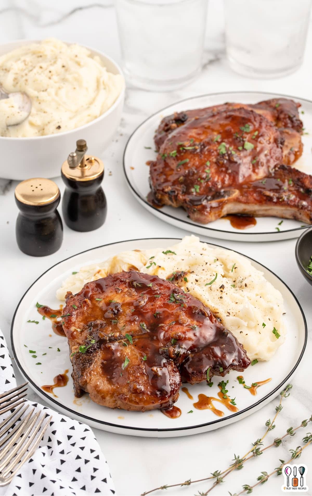 glazed pork chops served on a plate with mashed potatoes