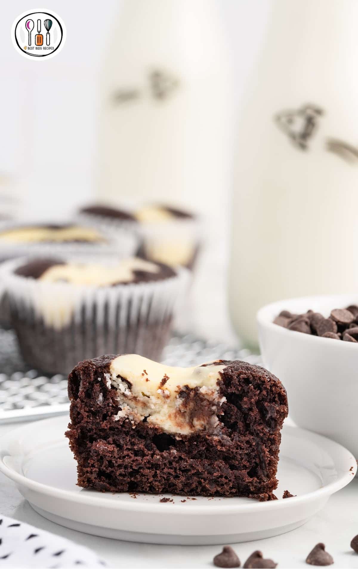 a close up shot of a Black Bottom Cupcake on a plate with a bite taken out of it