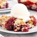 a serving of blackberry crumble on a white plate