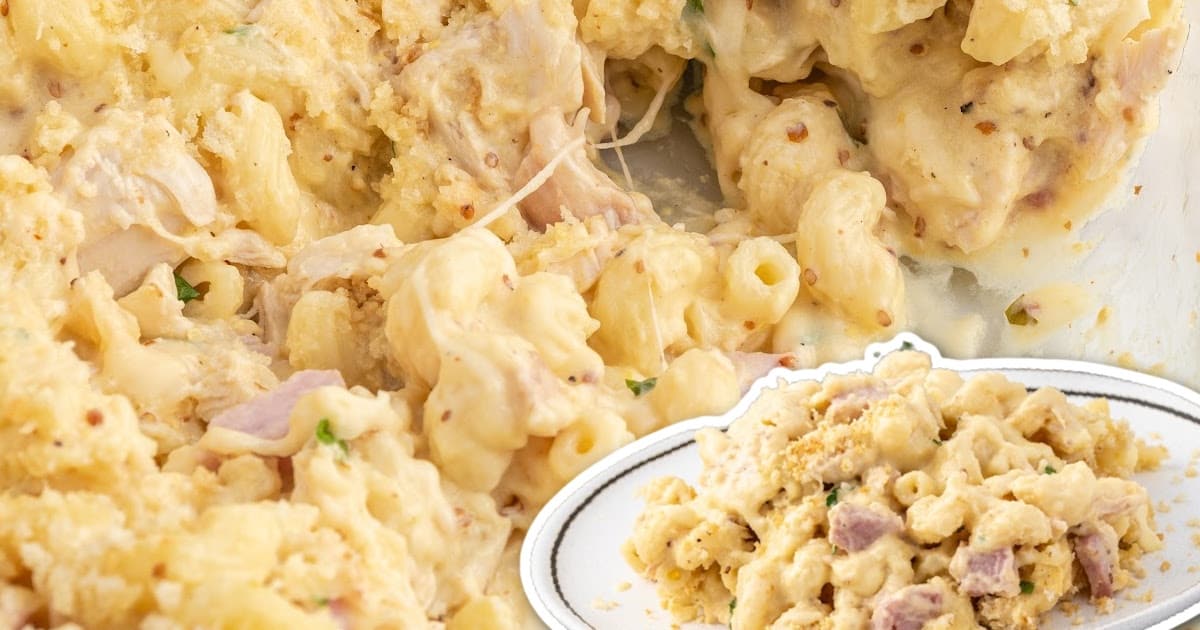 a close up shot of Chicken Cordon Bleu Casserole in a baking dish with a wooden spoon grabbing a piece