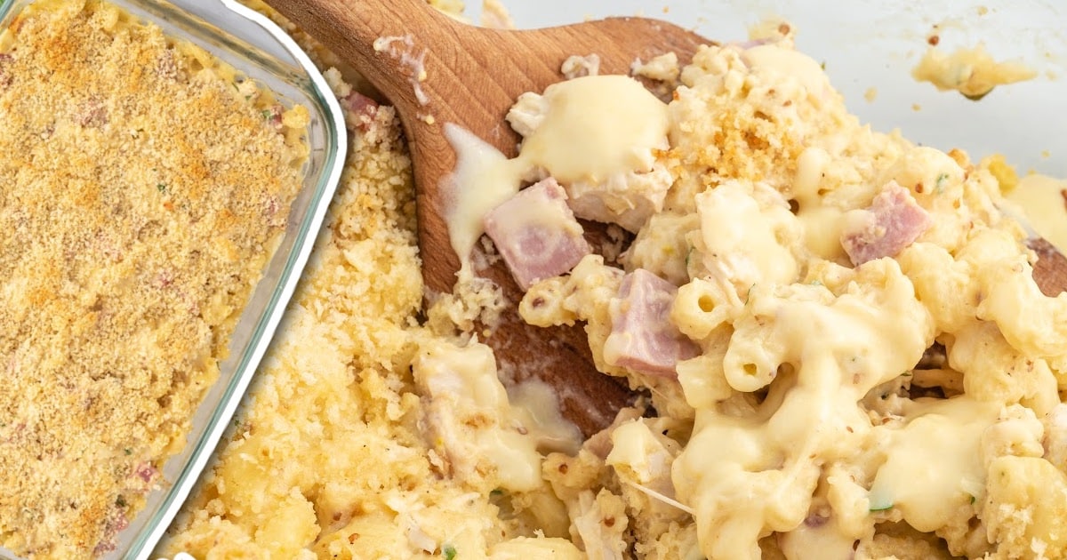 a close up shot of Chicken Cordon Bleu Casserole in a baking dish with a wooden spoon grabbing a piece
