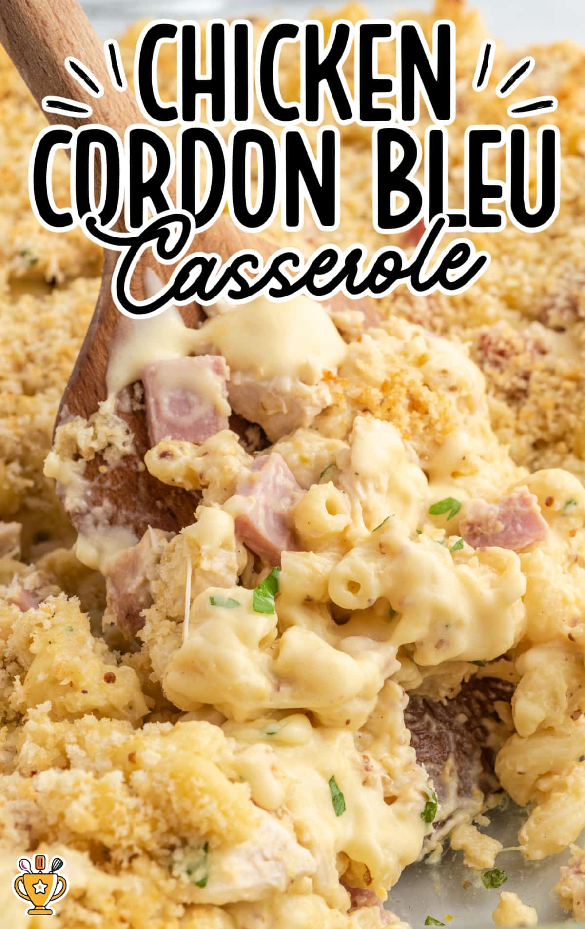 chicken cordon bleu casserole with wooden spoon scooping out a serving