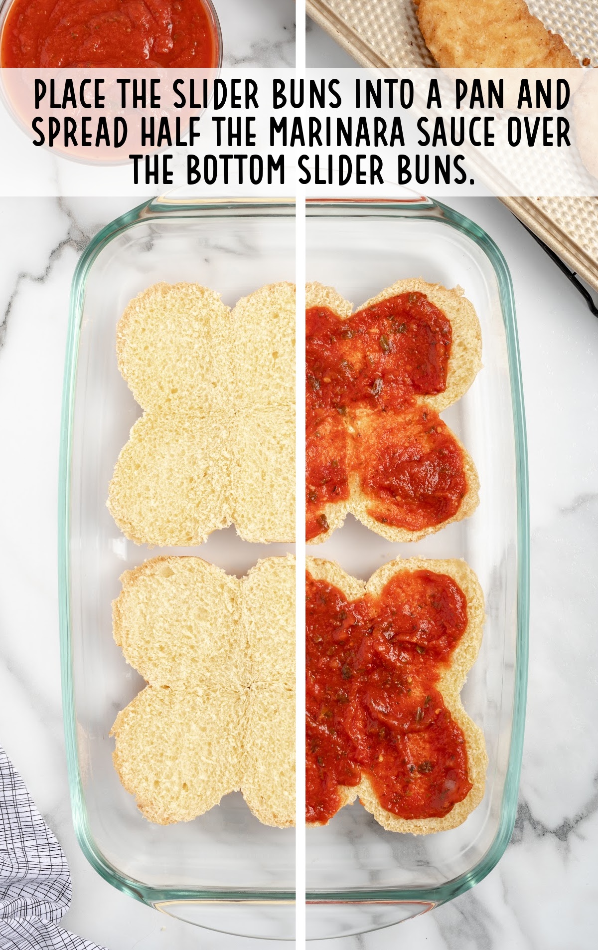 marinara sauce placed on top of the buns in a baking dish