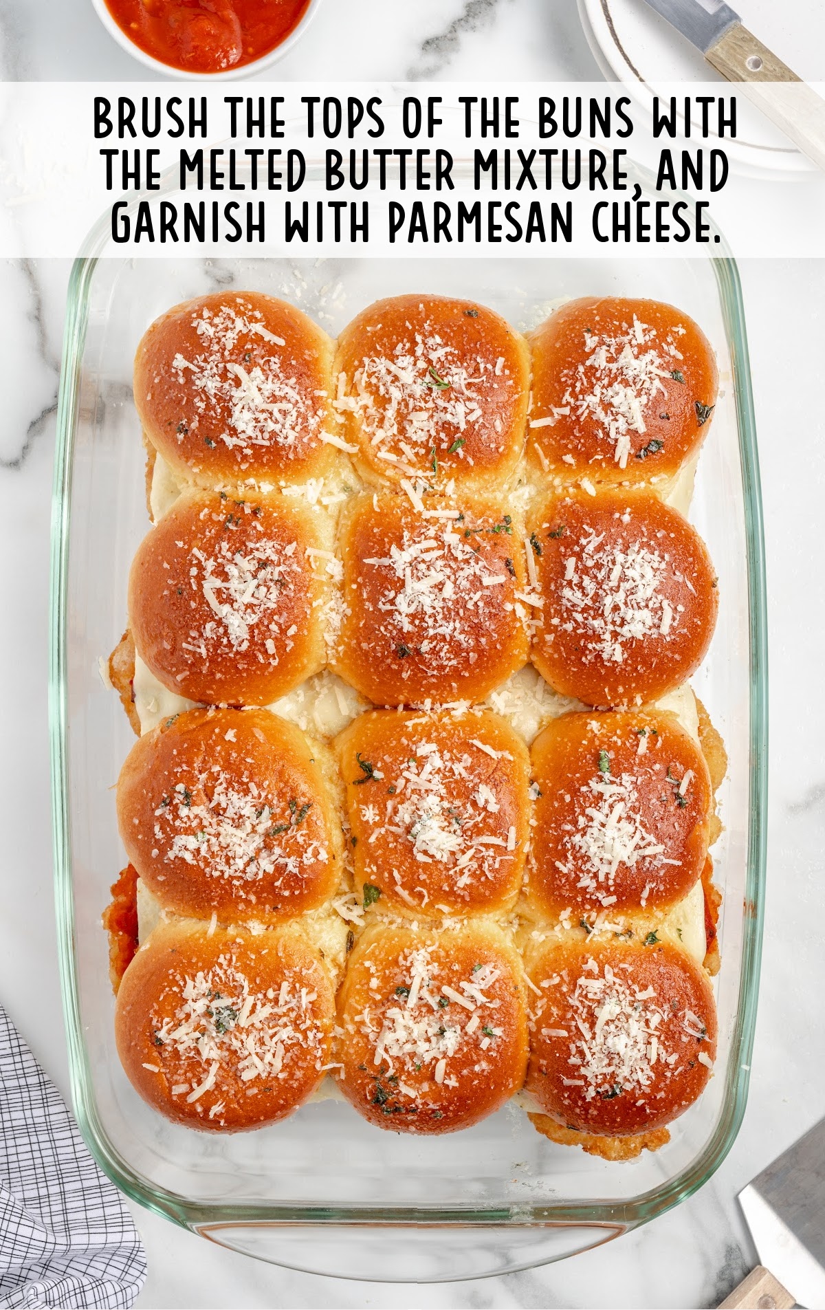 slicers topped with melted butter mixture and parmesan cheese in a baking dish