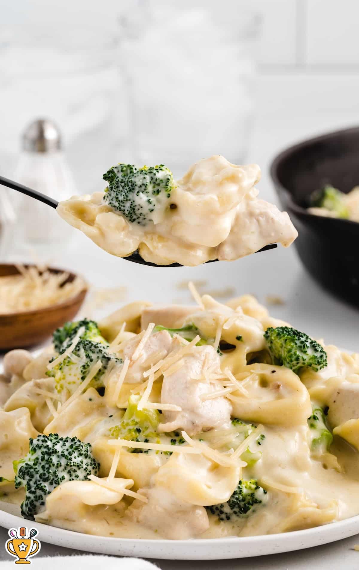 a close up shot of Chicken Tortellini on a skillet with a fork grabbing a piece